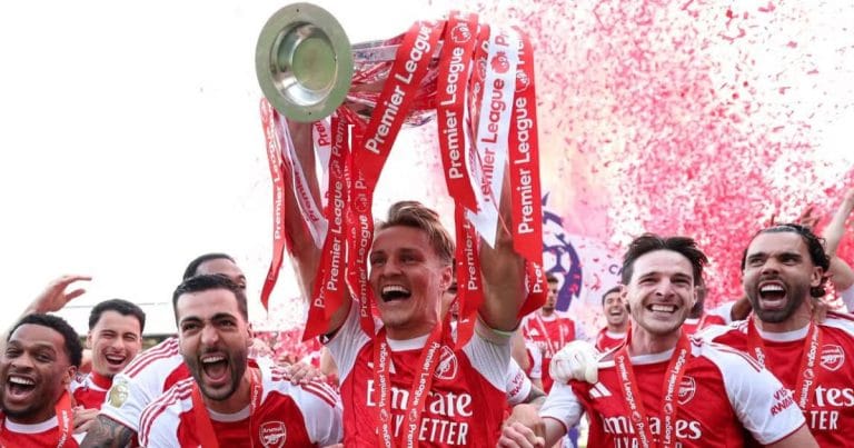 Arsenal players celebrating a victory on the pitch during the 2026 season