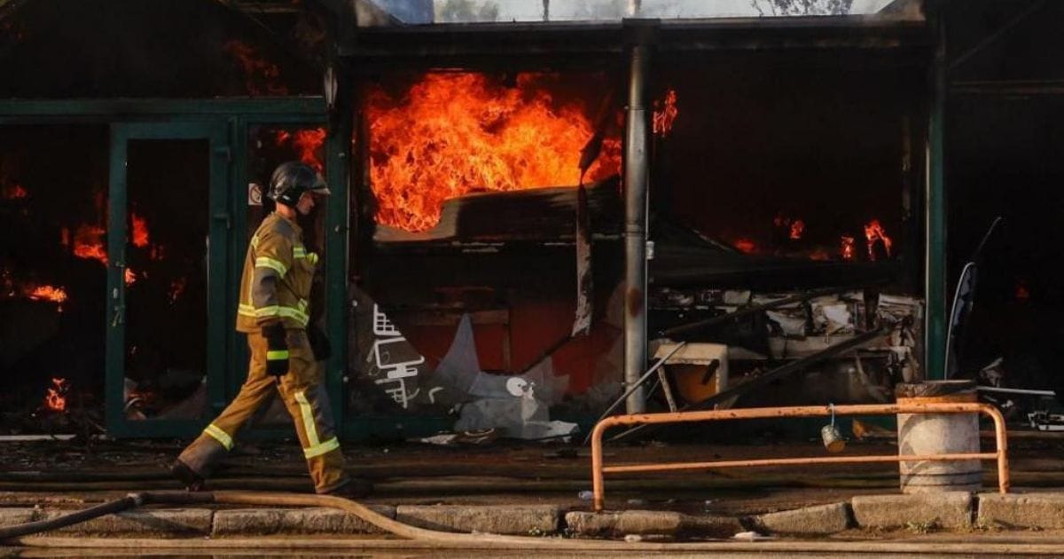 Emergency responders at the site of the Kyiv market hit during the Russian drone strikes.