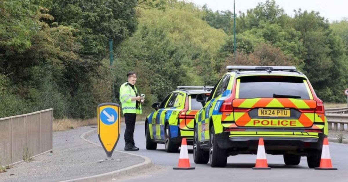 Emergency response vehicles and wreckage at the scene of a fatal collision involving a police car and a passenger vehicle