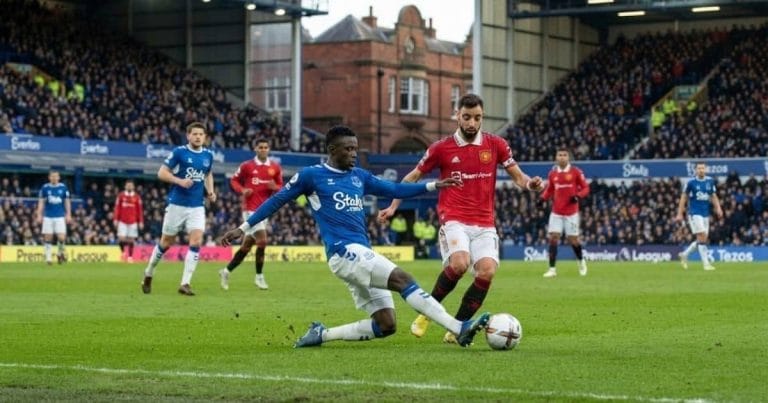 Premier League action at Goodison Park: Everton's Idrissa Gana Gueye in a sliding tackle against Manchester United's Bruno Fernandes.