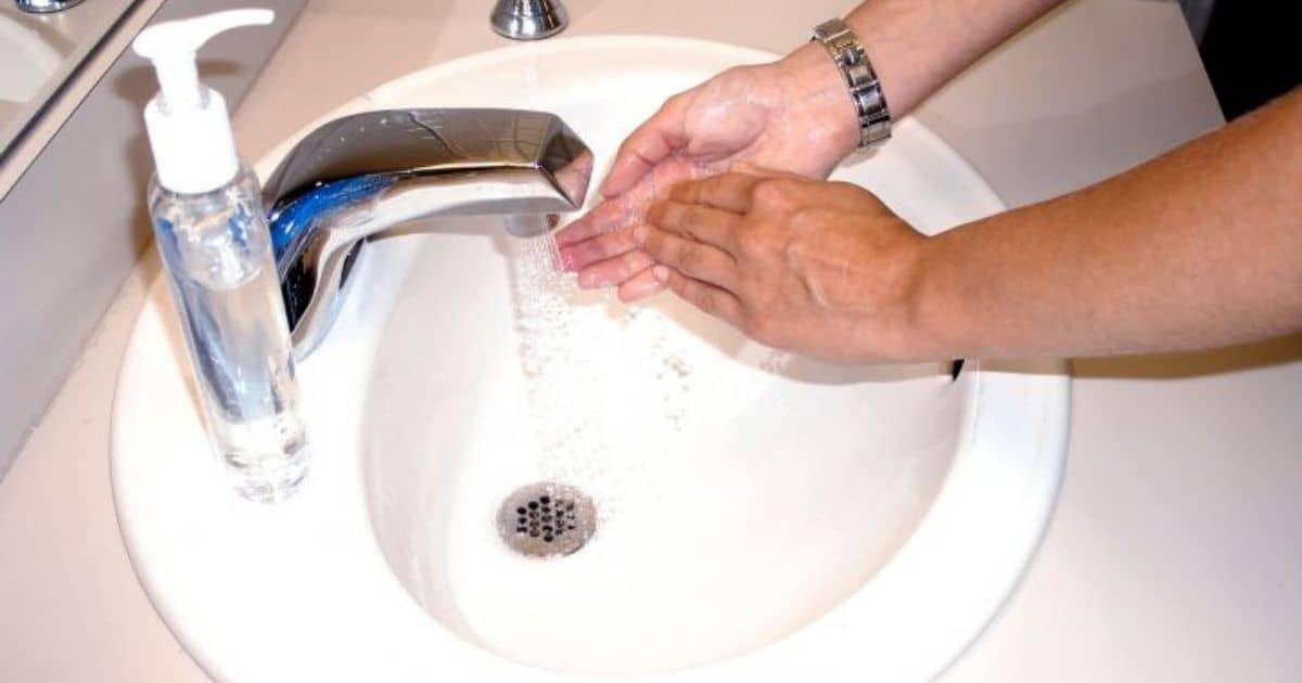 Person washing hands with soap and water over a sink - BDUS News 24