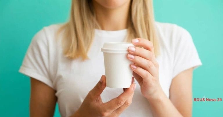 Student holding a coffee cup