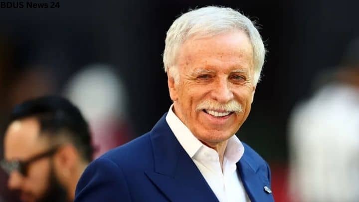 Billionaire sports owner Stan Kroenke pictured wearing a blue cap during a major franchise announcement.