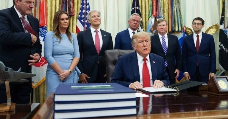 Donald Trump signing documents