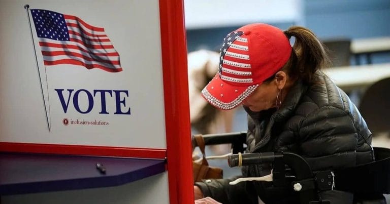 A voter casting a ballot at a polling booth in the United States.