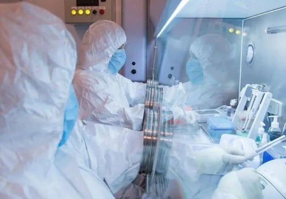 Researchers in protective suits working in a specialized laboratory environment, relating to the Siberian plague institute safety investigation.